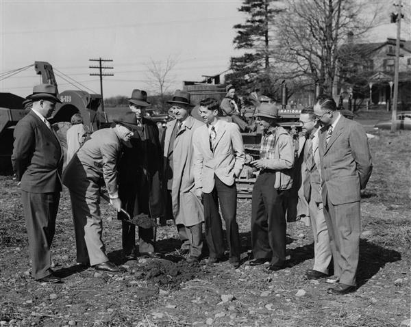 Black and white photo of several men at the groundbreaking ceremony